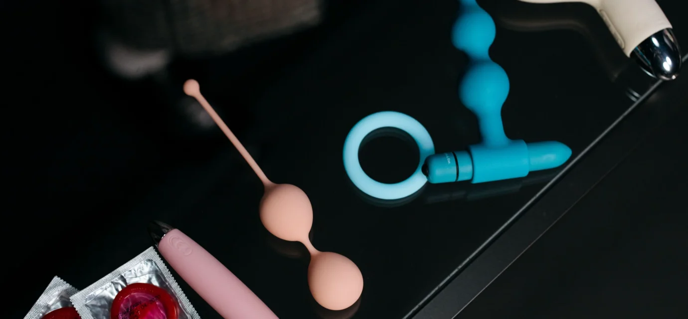 An adult holding a compact purple remote-controlled sex toy