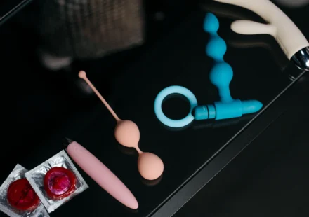 An adult holding a compact purple remote-controlled sex toy