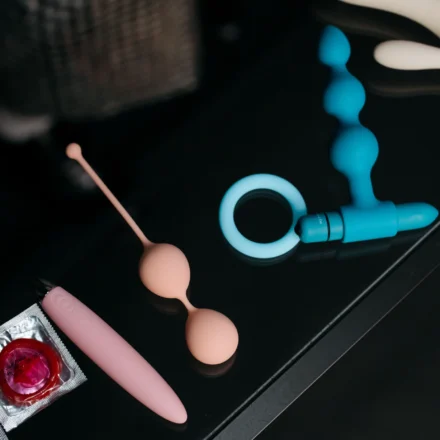 An adult holding a compact purple remote-controlled sex toy