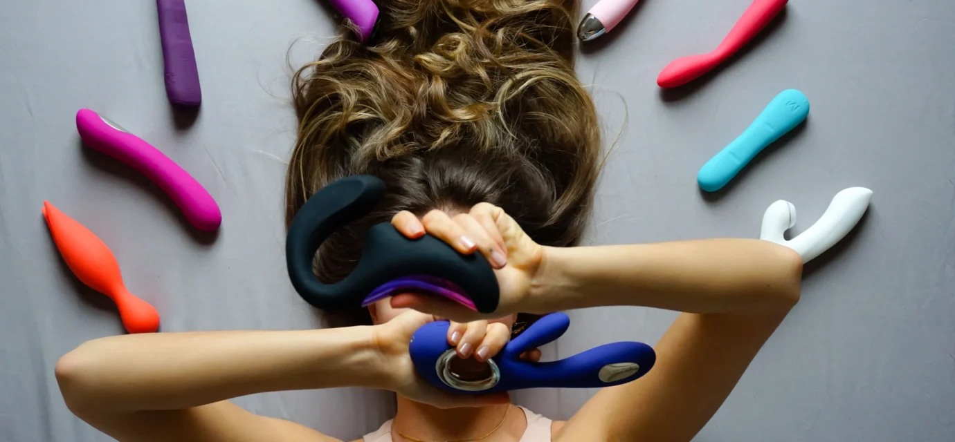 Assorted sex toys displayed on a bright background
