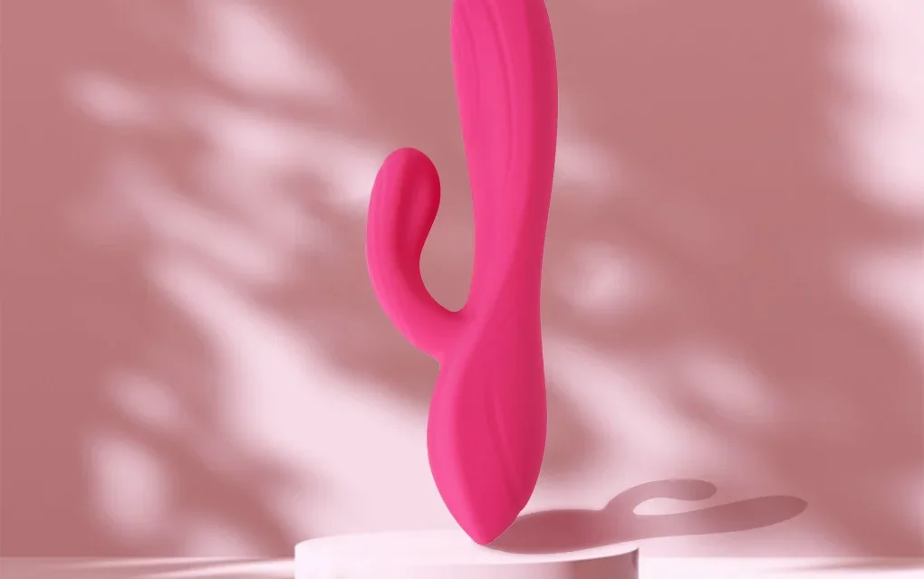Pink rabbit vibrator displayed against a soft pink background