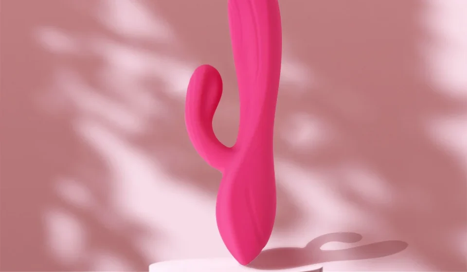 Pink rabbit vibrator displayed against a soft pink background